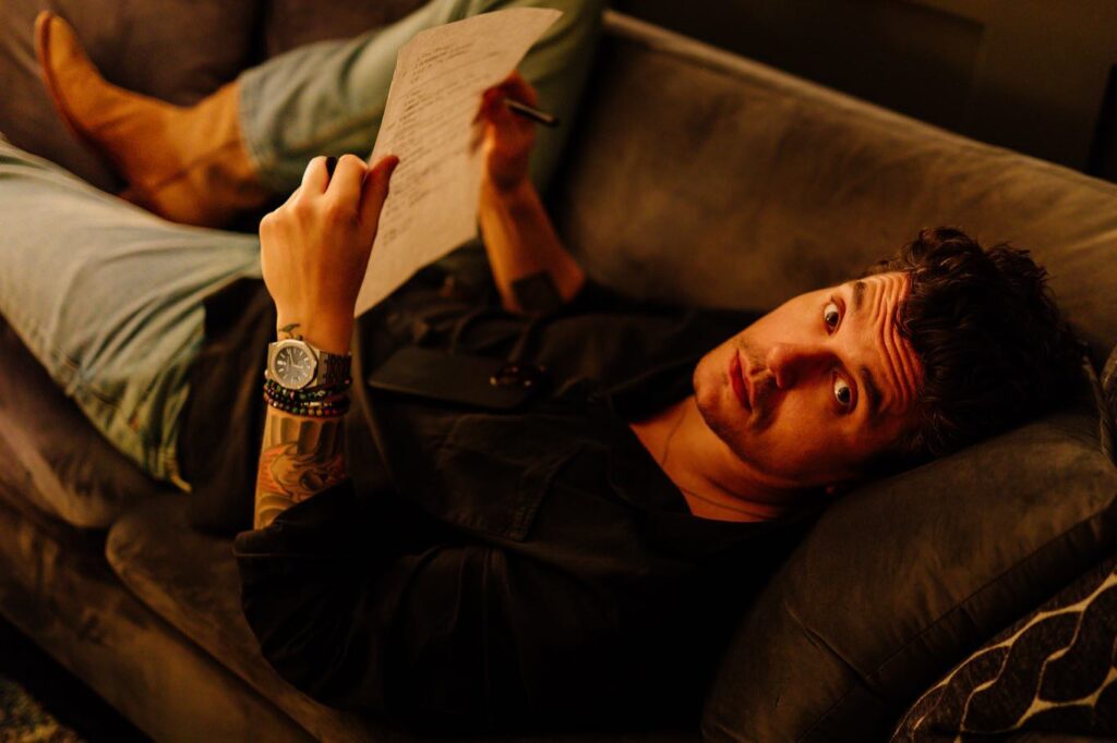 John Mayer during a review session of a song's lyrics. Audemars Piguet watch on his wrist
